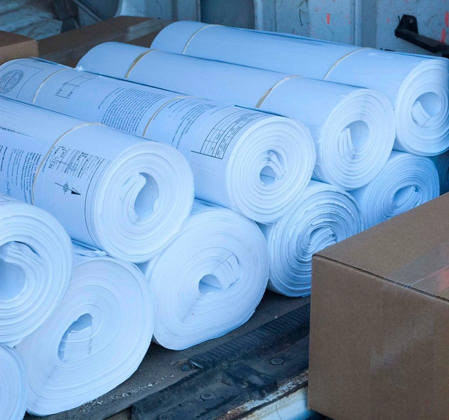 Rolled and banded plan sets loaded for delivery to a job site