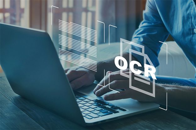 Scanned pages being converted to searchable text on a laptop